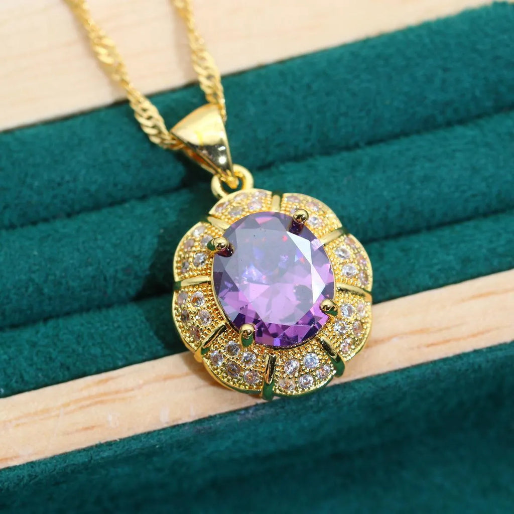 Gold plated women's jewellery set with necklace, earrings, ring, and bracelet featuring coloured zircon stones.