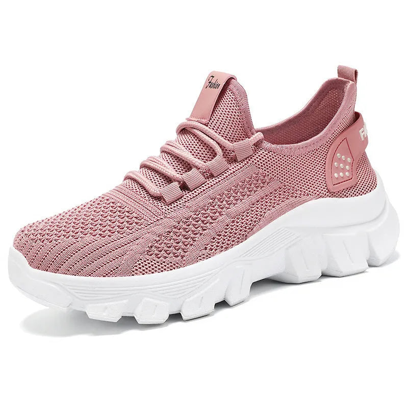Women's white Flyknit sneakers with thick PVC sole and lace-up front.