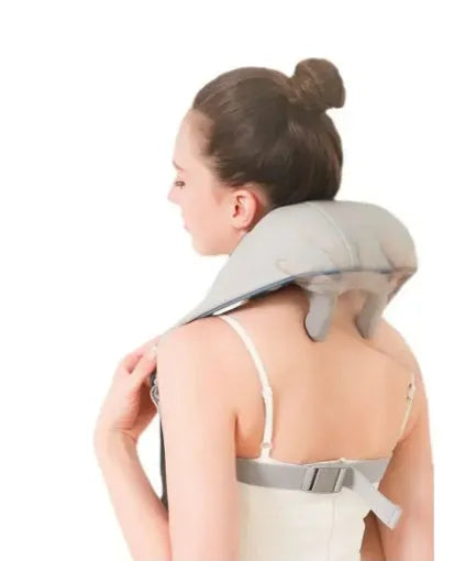 Milky white rechargeable shoulder and neck kneading massager on a plain background.