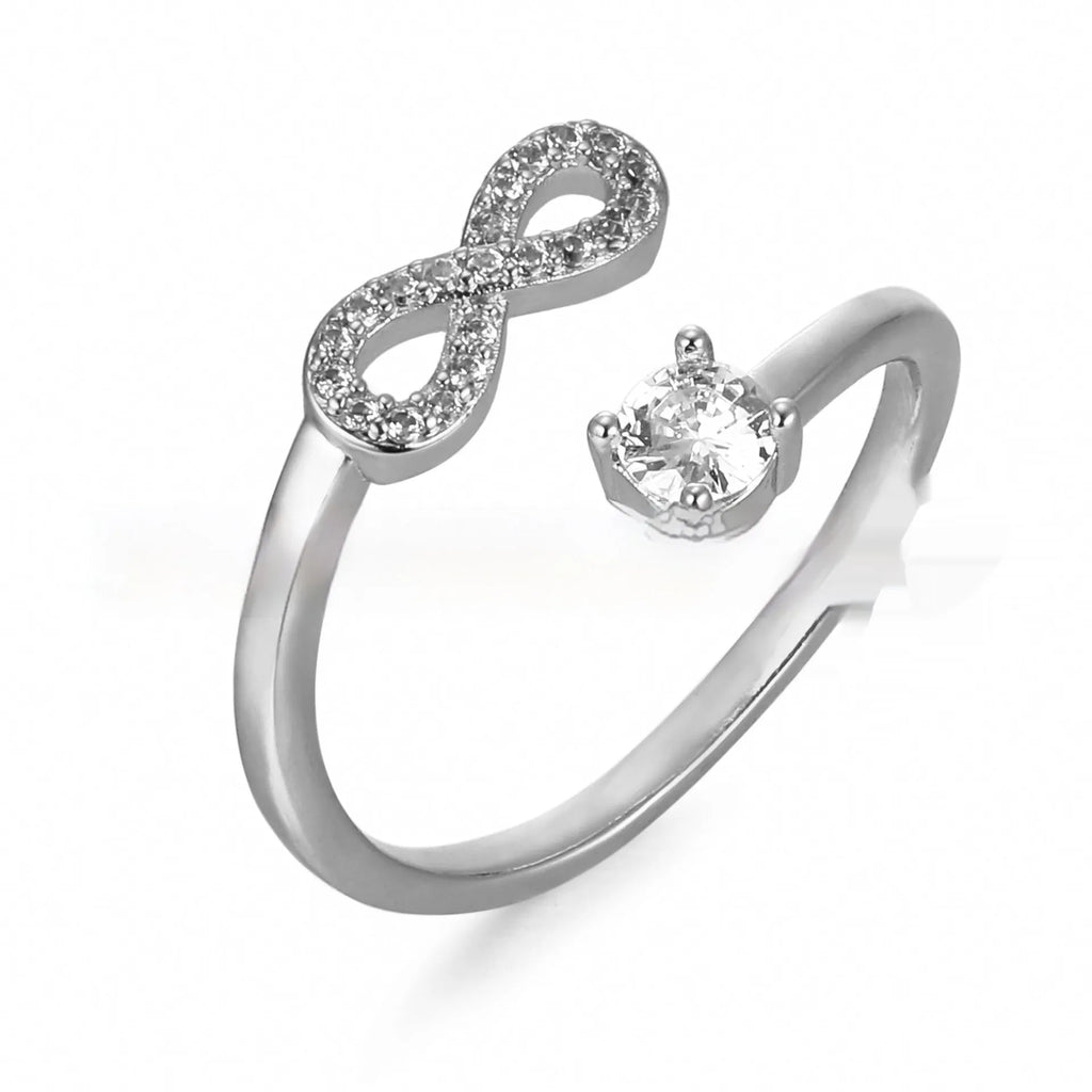 Geometric open ring with a single inlaid zircon letter on a metal band, shown in gold, rose gold, and silver finishes.
