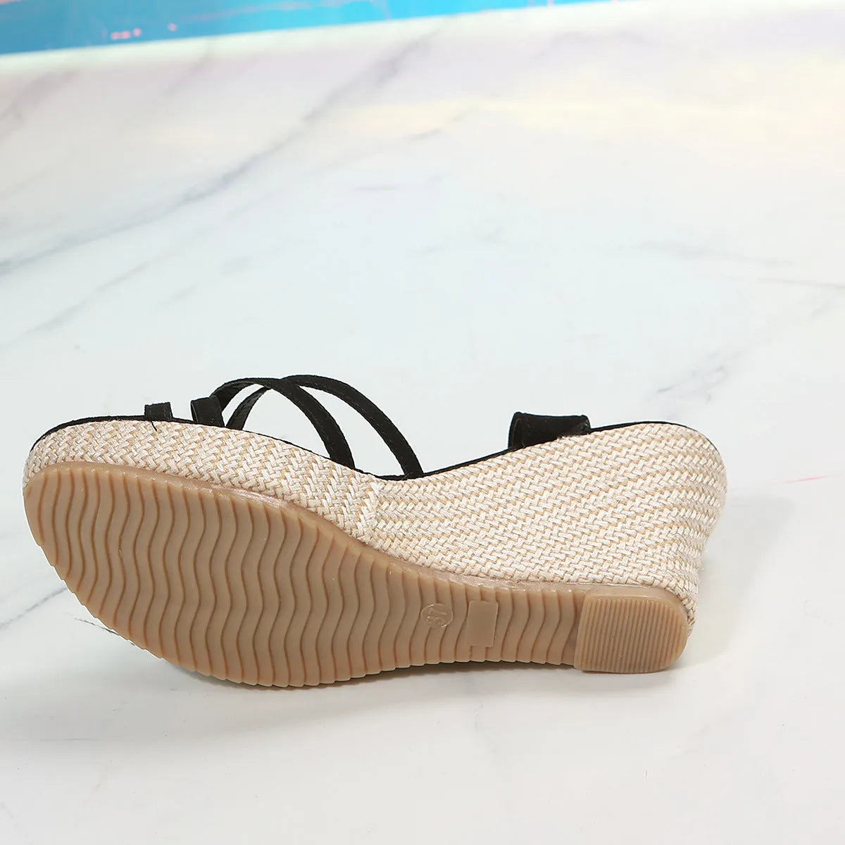 Women's beige wedge sandals with a fish mouth toe opening and cloth upper.