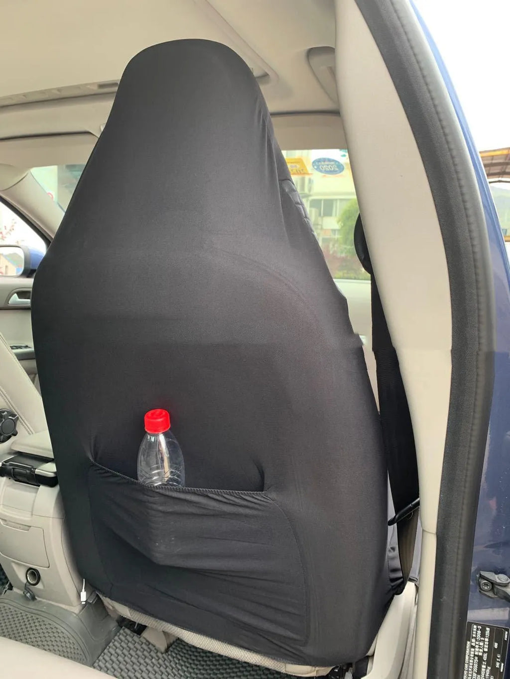 Black quilted car seat cover made from PU and polyester fabric with plastic installation hooks.