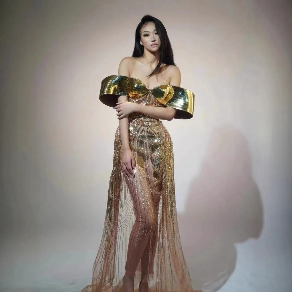 Gold strapless sequined dress with long split skirt on a mannequin