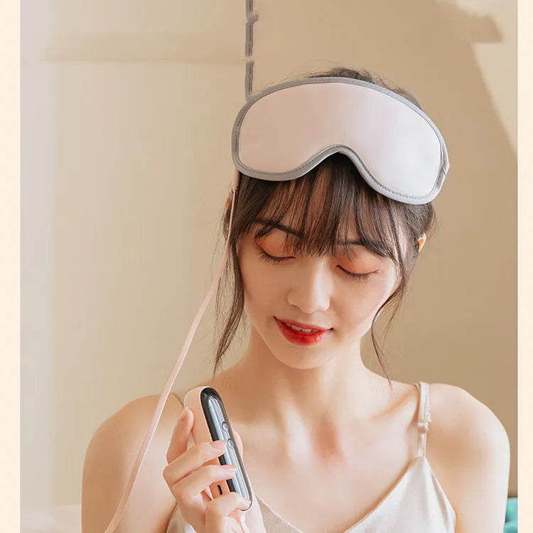 Portable green eye SPA massage goggles with suede shell on a grey background.
