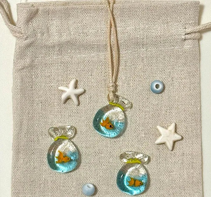 Women's joker charm necklace with coloured glaze pendant on a cotton and linen clavicle chain.