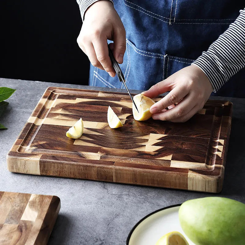 Brown solid acacia wood cutting board with 3cm thickness on a kitchen counter.