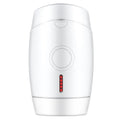 White home laser hair removal device on a table showing its compact size.