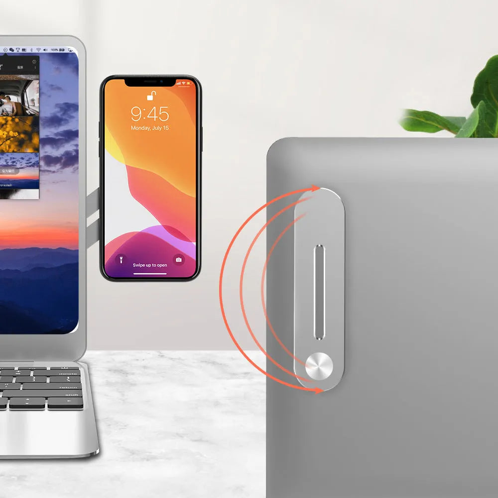 Silver aluminium laptop bracket holding a smartphone next to a laptop screen.