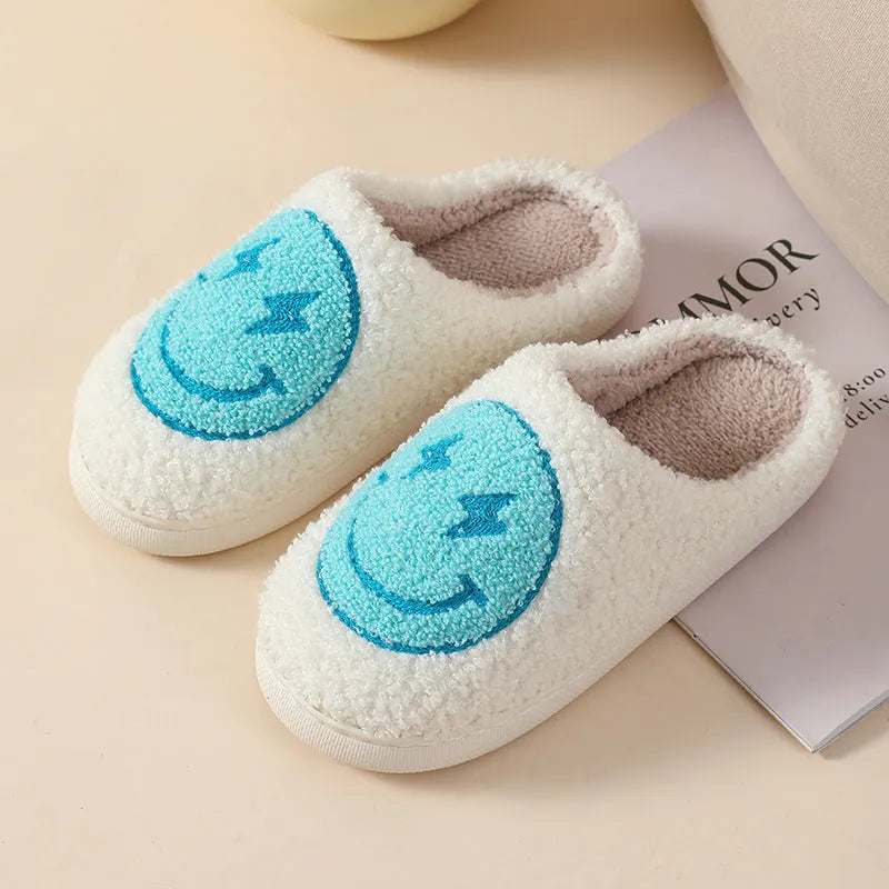 Women's plush home slippers in cartoon love style print with round toe and non-slip PVC sole.