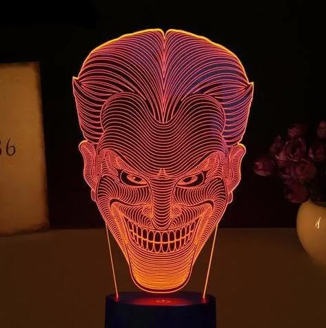 A 3D acrylic LED lamp displaying a gradient of colours, sitting on a square base with a USB cable.