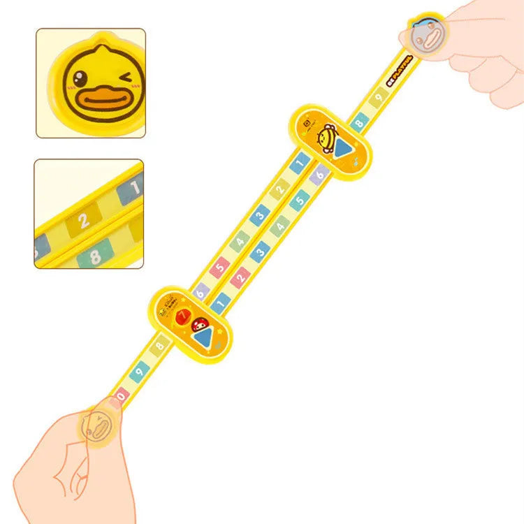 A yellow plastic children's cartoon digital decomposition ruler showing measurements up to 24.5 cm.