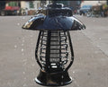Black solar-powered mosquito lamp with solar panel and white LED light for outdoor insect control