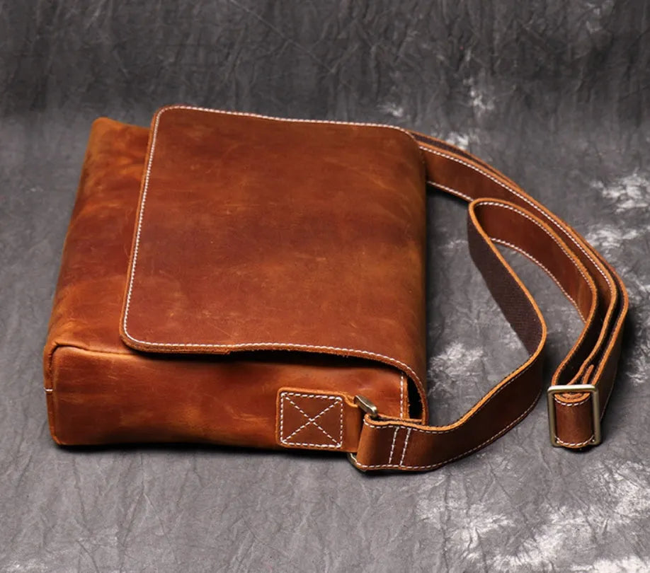 Men's vintage brown leather messenger bag with flap cover and adjustable shoulder strap
