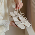 Women's flat strap open-toed Roman sandals in Microfiber with a square toe, shown in beige colour.