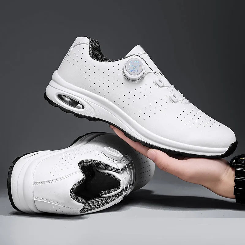Low-top black and white casual tennis shoes with mesh upper and flat composite sole.