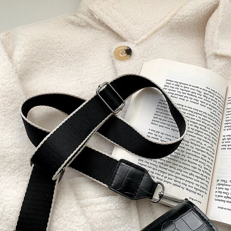 Vintage PU leather crossbody bag in black, shown with adjustable strap.