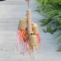 Colourful shredded paper parrot toy with wood and sisal construction hanging