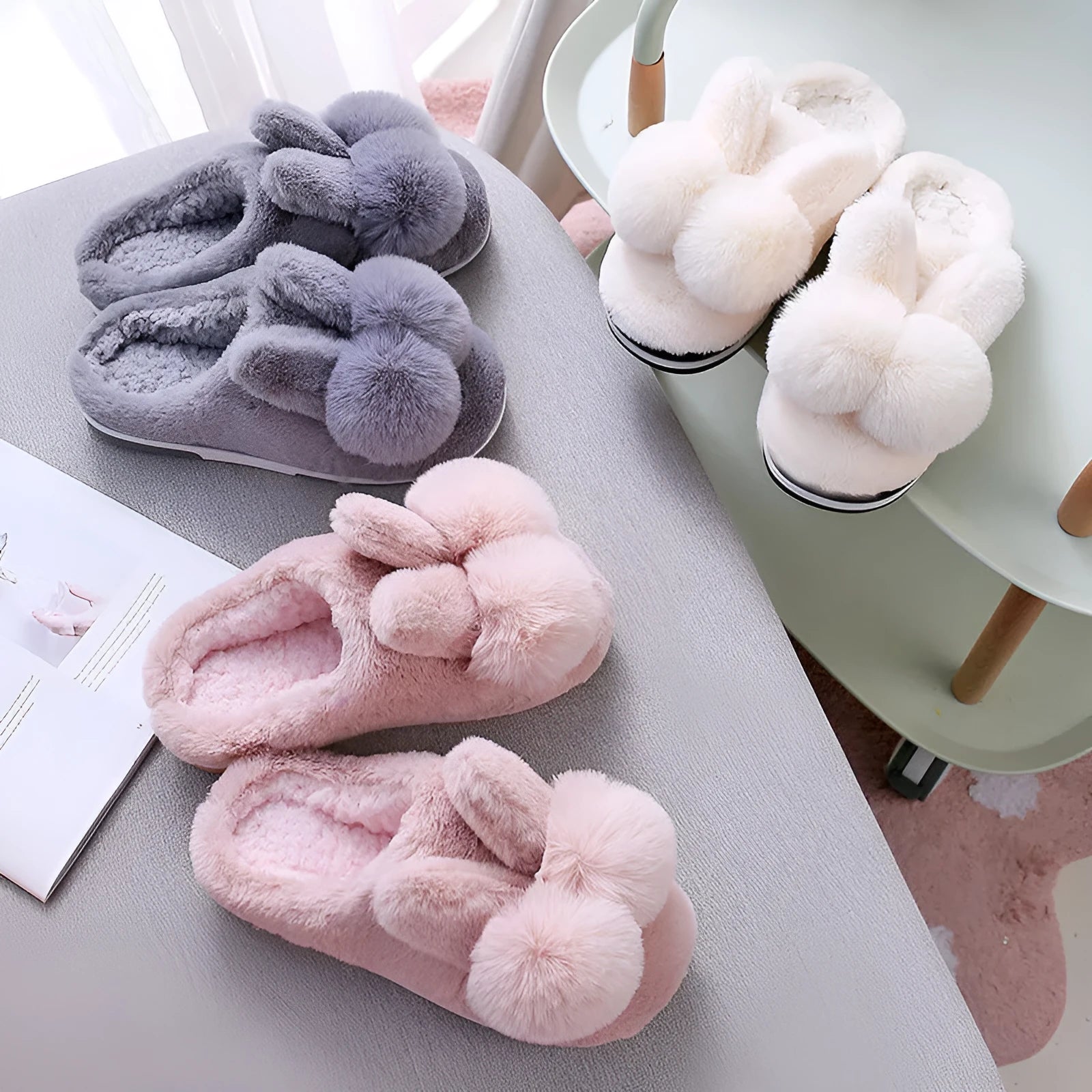 Women's fluffy bunny slippers with rabbit fur upper in cream colour on a wooden floor.