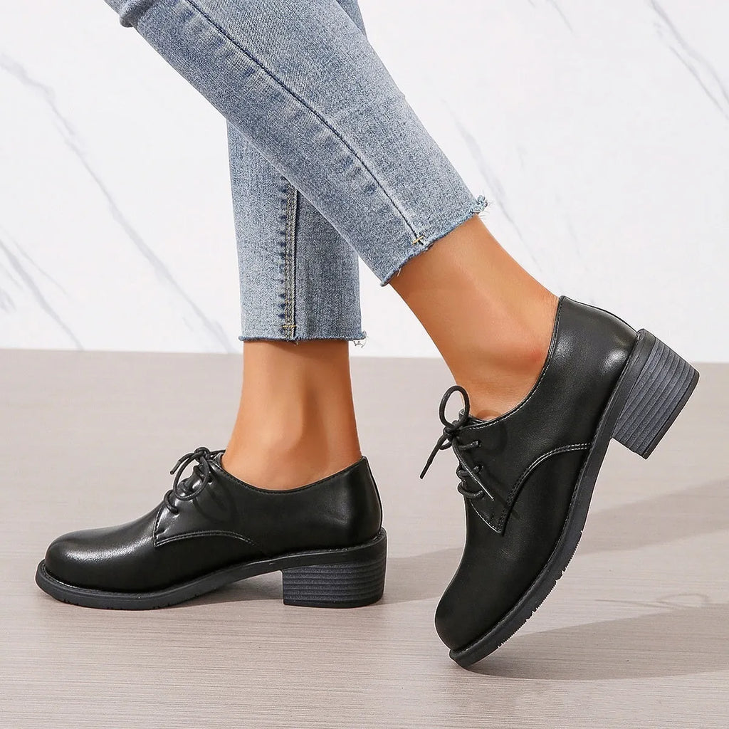 Black women's leather shoes with chunky heel, rubber sole, and low-top design for work and casual wear