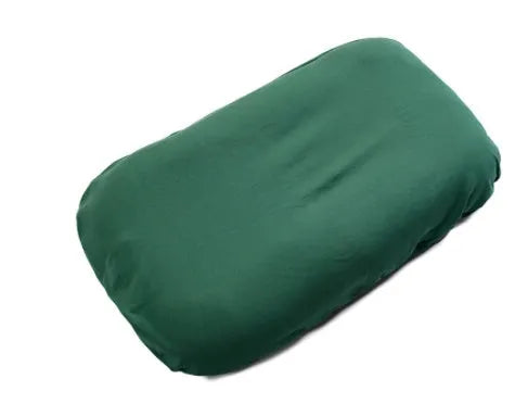 Beige portable cotton baby nest crib for newborn infants on a bed.