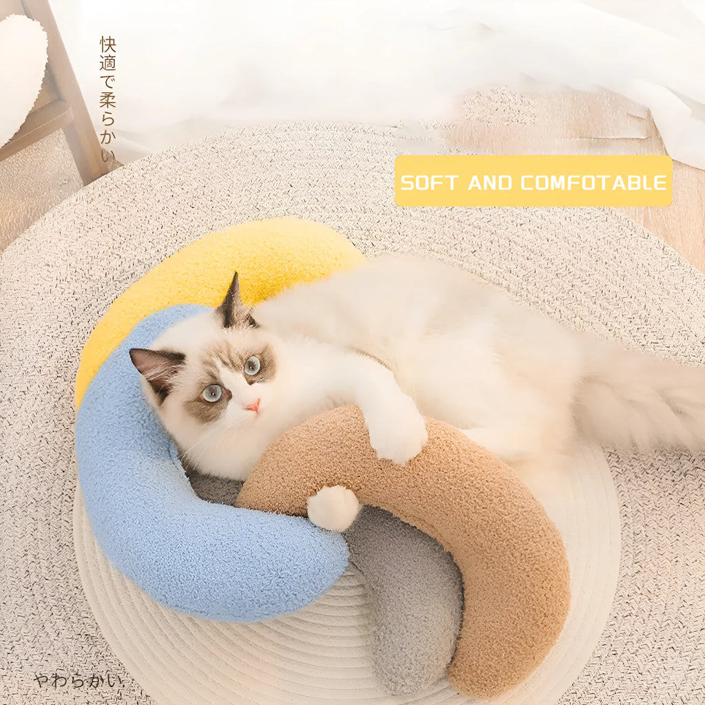 Blue U-shaped cat pillow with an adjustable fabric collar for neck support.