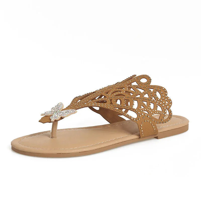 Women's black slip-on sandals with rhinestone details on hollow upper and flat rubber sole