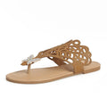 Women's black slip-on sandals with rhinestone details on hollow upper and flat rubber sole