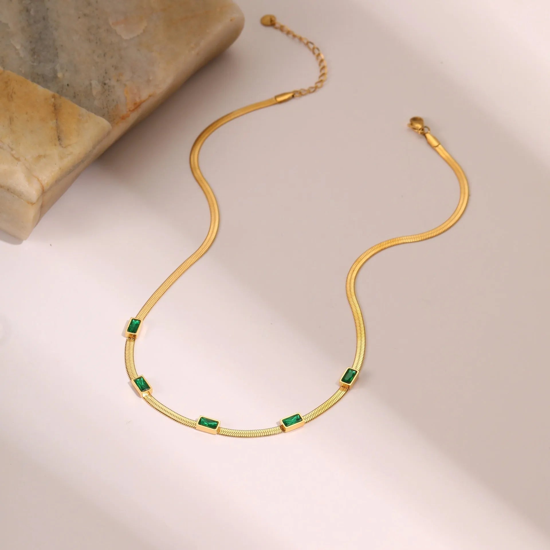 Retro geometric square zircon necklace on flat snake-style stainless steel chain in gold finish