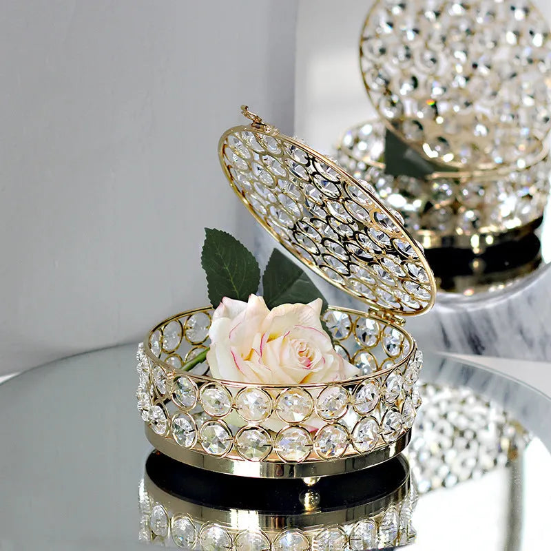 French gold metal jewellery box with a transparent crystal glass lid on a table.