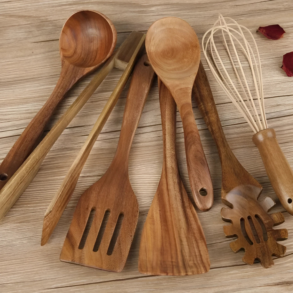Seven-piece set of wooden cooking utensils including spoons and shovels on a kitchen counter.
