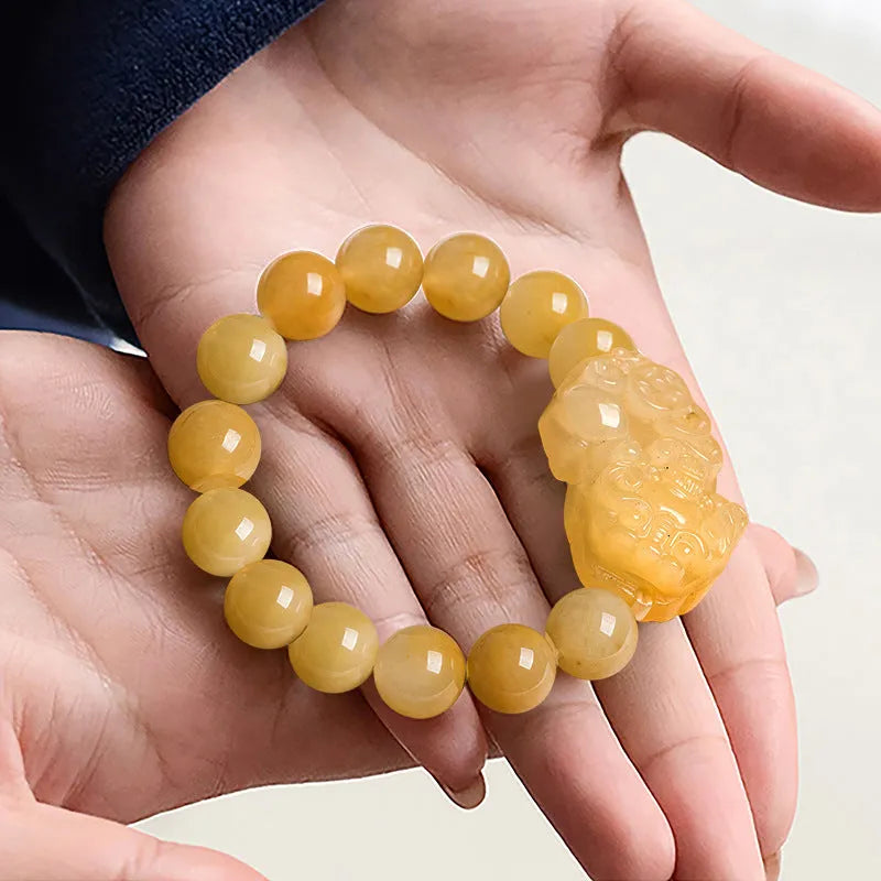 Carved Jinsi jade money bracelet showing golden thread texture and bead details