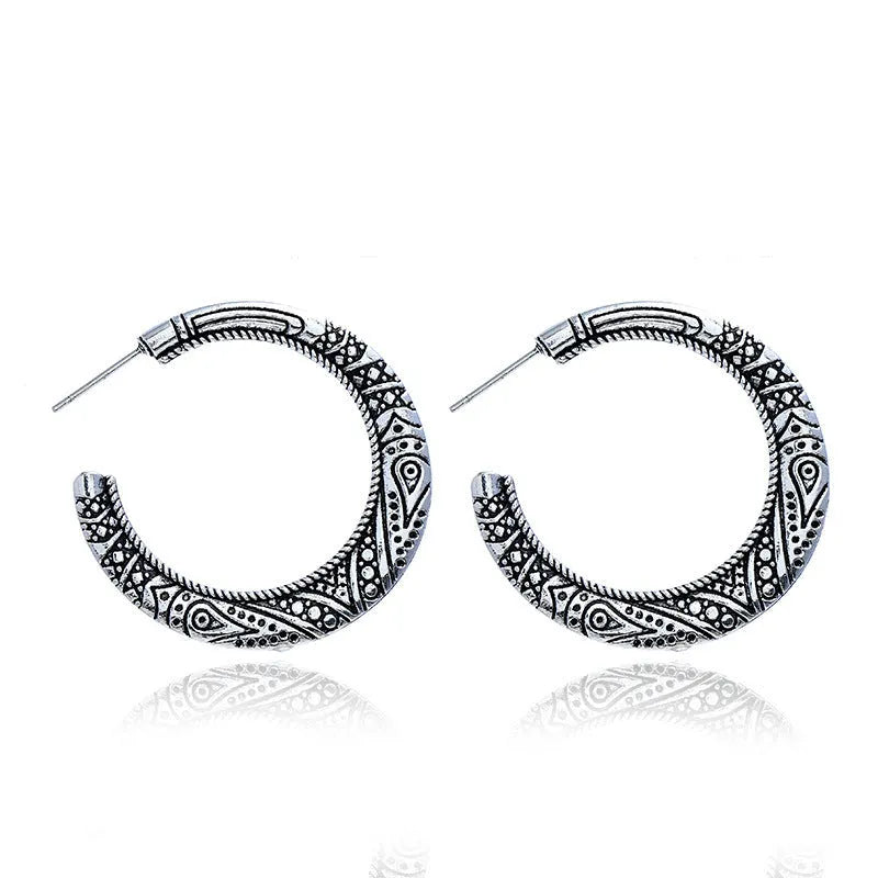 Vintage engraved C-shaped alloy drop earrings in bronze tone on a white background.