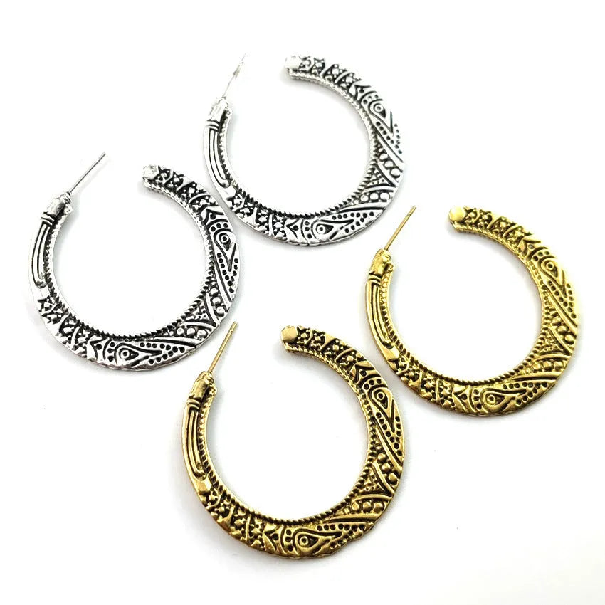 Vintage engraved C-shaped alloy drop earrings in bronze tone on a white background.