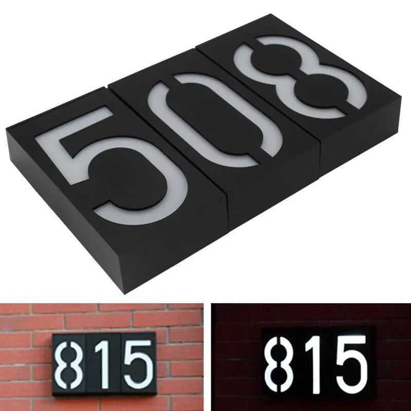 Solar powered house number light with white LED and waterproof casing mounted on an exterior wall