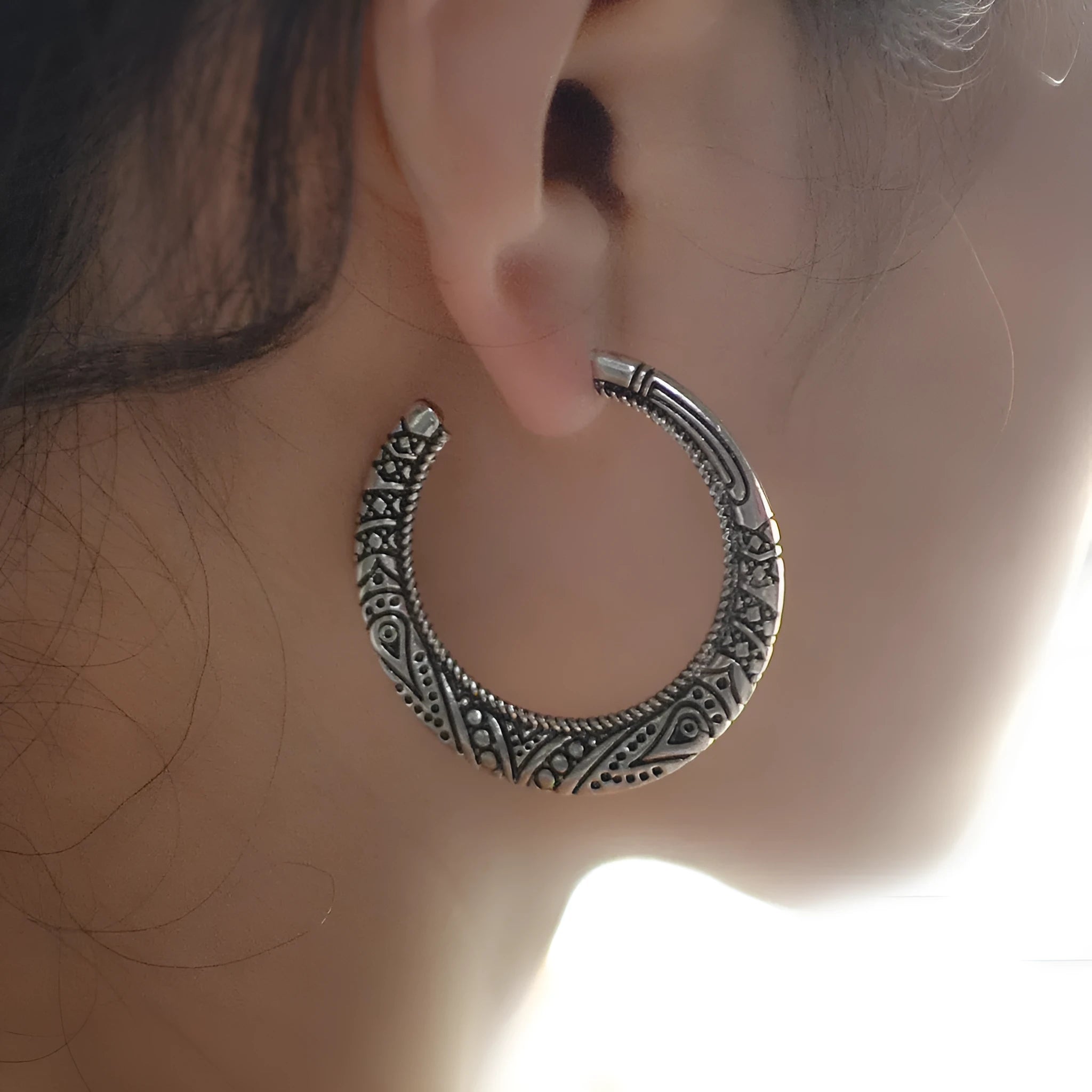 Vintage engraved C-shaped alloy drop earrings in bronze tone on a white background.