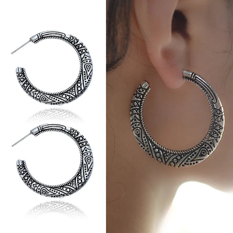 Vintage engraved C-shaped alloy drop earrings in bronze tone on a white background.