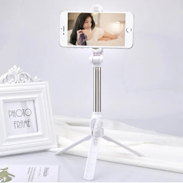 Black Bluetooth selfie stick with extended tripod legs and a phone clip rotated for horizontal filming.