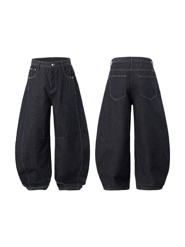 Men's wide leg denim trousers in original cow colour, showing mid waist and loose leg fit.