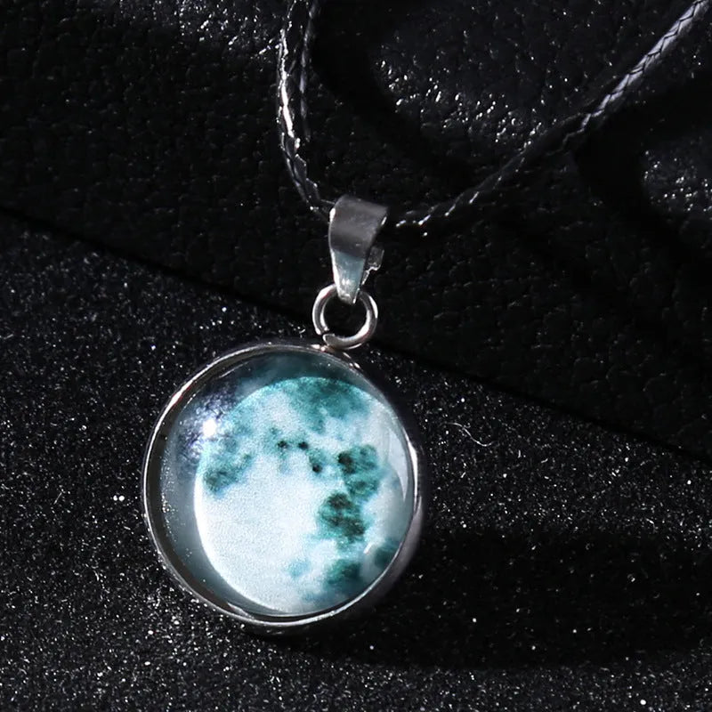 Luminous moon and constellation pendant necklace on a chain with an extension, shown in one of ten possible colours.