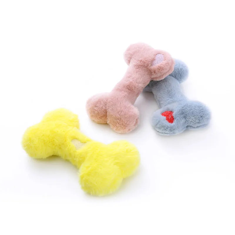 Blue, pink and yellow bone-shaped plush dog toys with squeaker for interactive play