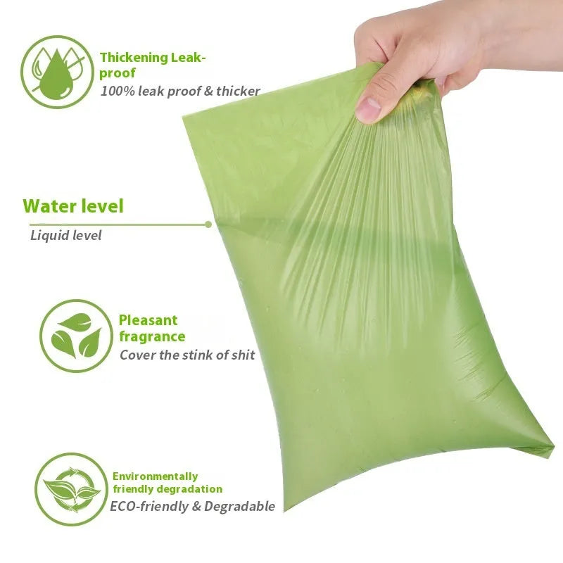 Roll of green EPI degradable dog poop bags next to a white dispenser on a table.