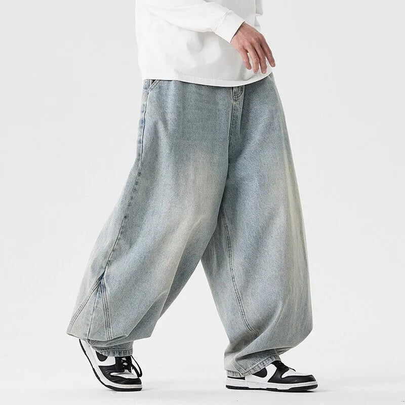 Men's plus size wide leg jeans in dark blue denim with a baggy fit and straight leg opening.