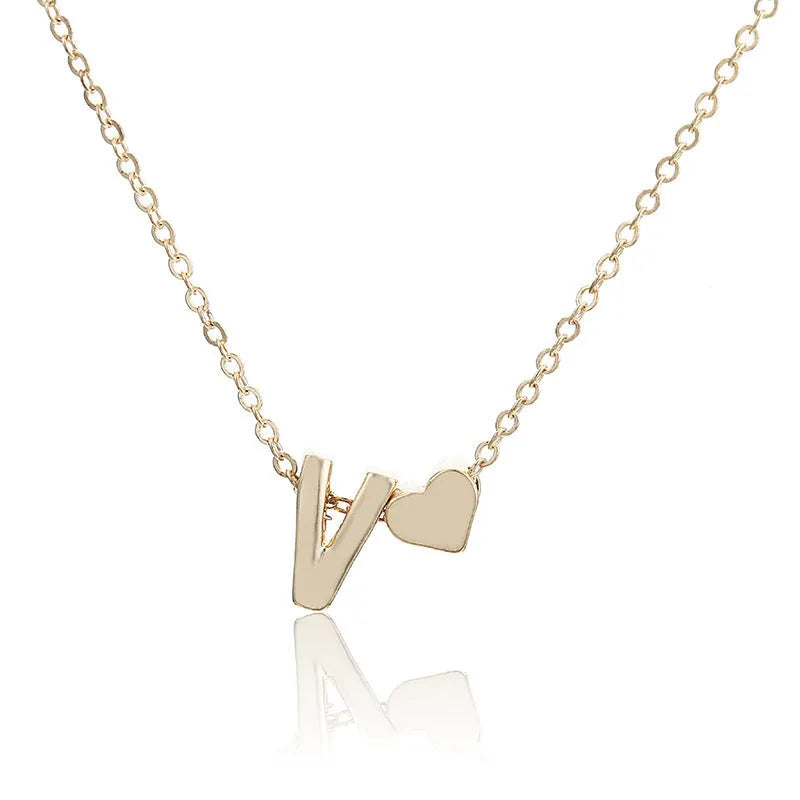 Gold and silver alloy peach heart shaped letter pendant necklace charm on a chain.