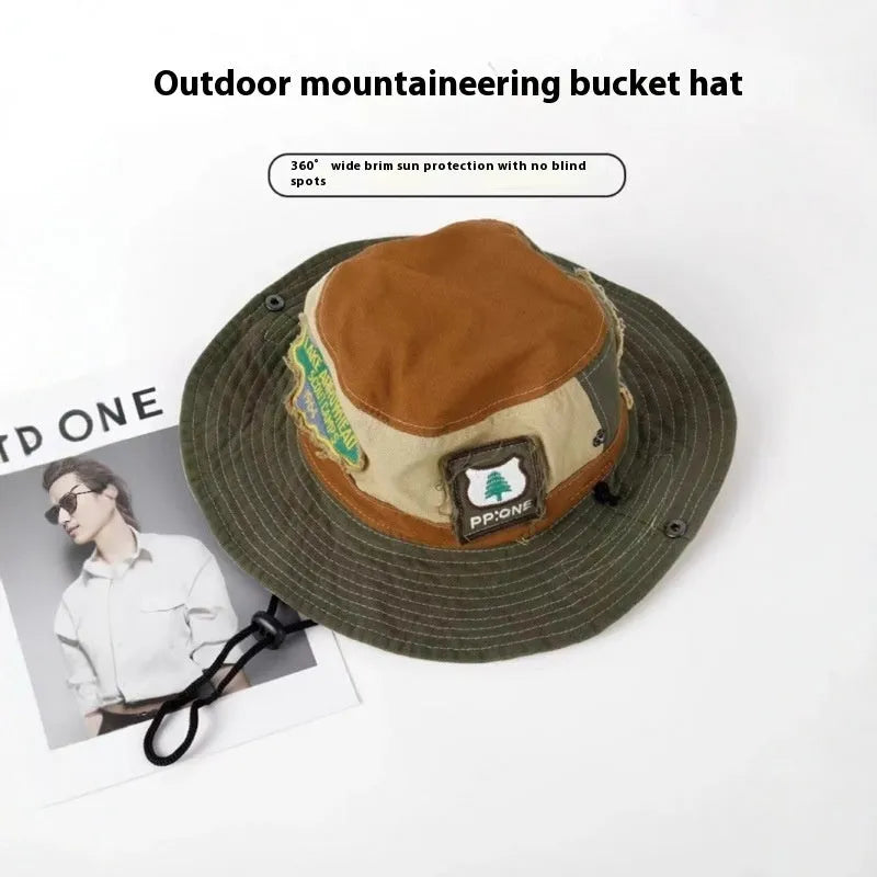 Army green cotton fisherman hat with flat top crown and hand-painted patchwork details, shown folded and unfolded