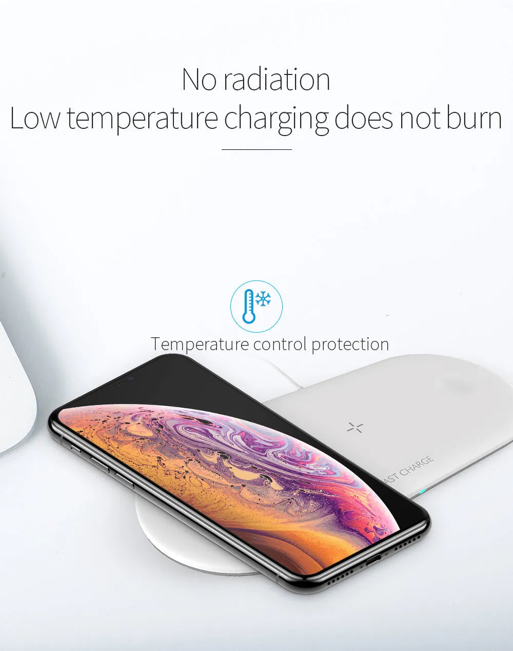Black and white three-in-one wireless charging station for iPhone, Apple Watch and headphones on a desk.