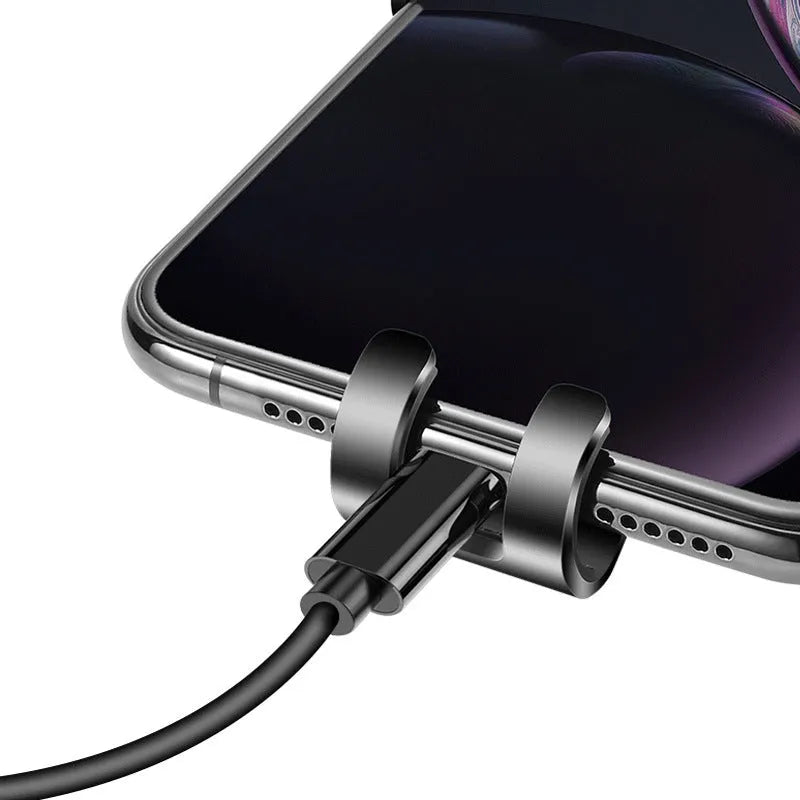 Black S4 gravity mirror ABS phone bracket clipped to a car air vent, holding a mobile phone.