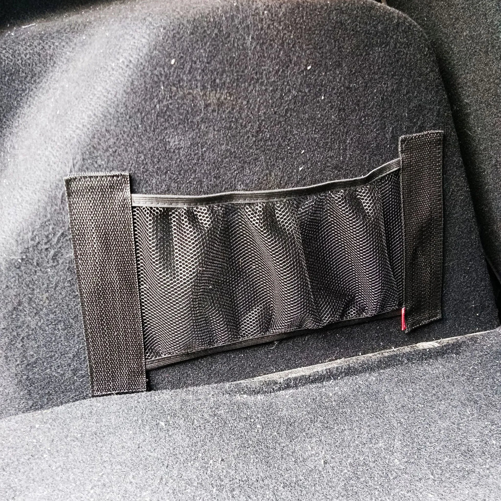 Black elastic polyester storage net for car boot organisation with hook-and-loop fasteners.