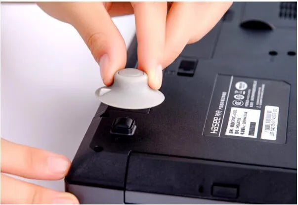 Four grey durable plastic laptop cooling pads in two sizes on a flat surface