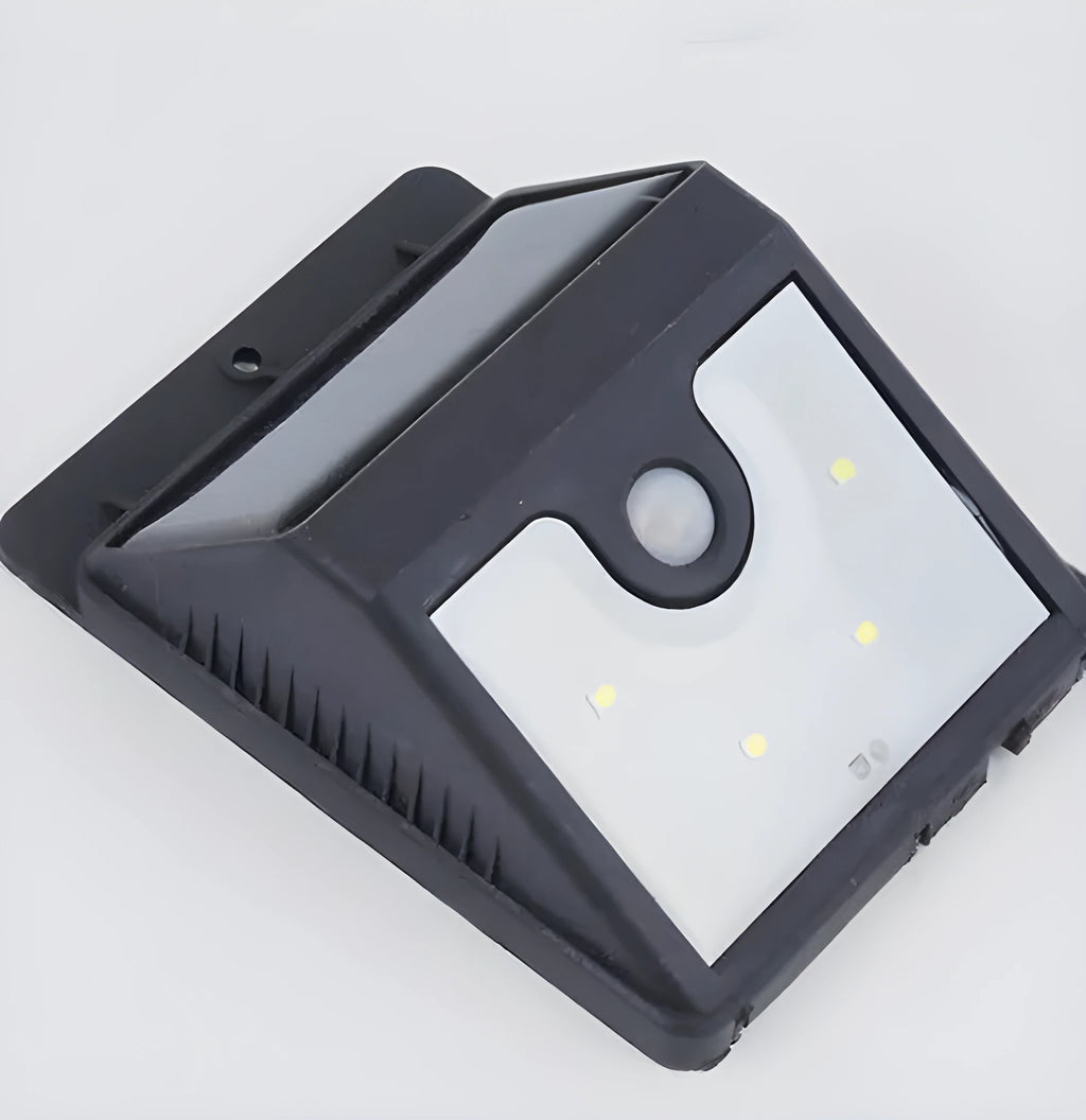 Four white solar-powered LED motion sensor lights for outdoor garden and pathway use.