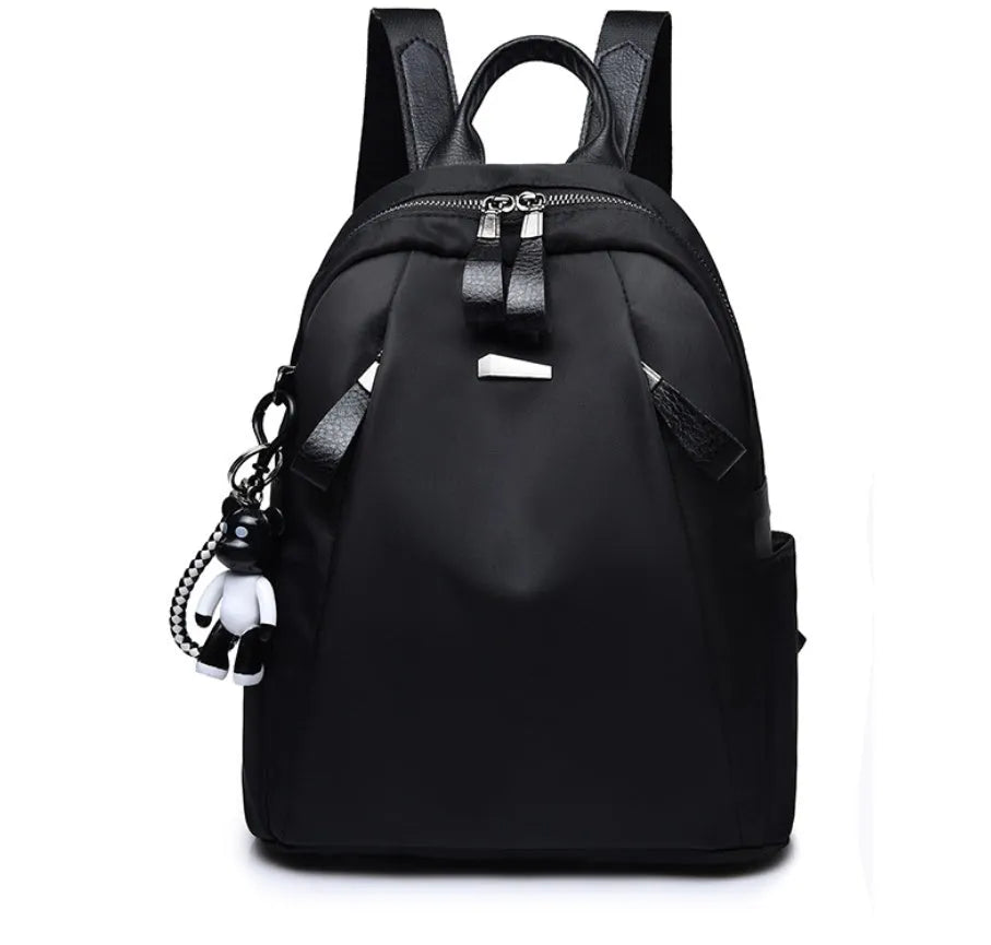 Medium-sized Oxford cloth rucksack in wine red, showing dual straps and external pocket.